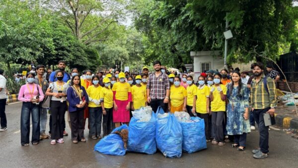 Maid In India Leads Cleanliness Drive at Delhi Protest Site. Yellow T-Shirts, Blue Bags, One Mission.